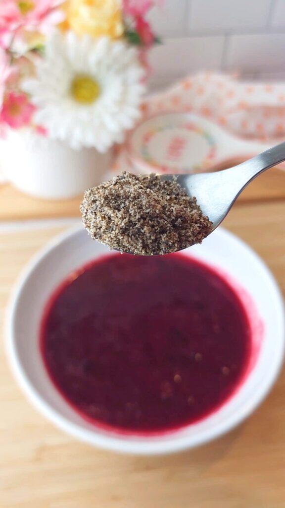 Blended chia seeds on a spoon - Looks like black pepper
