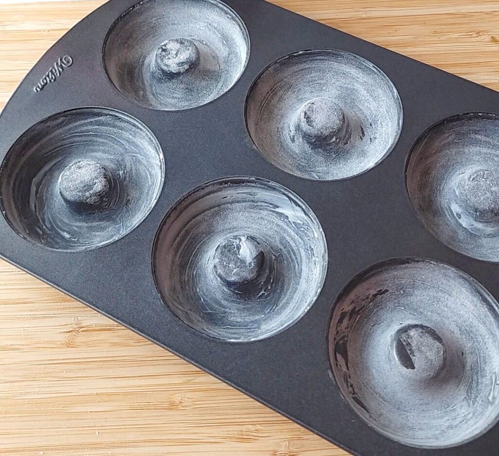 Buttered and floured donut pan