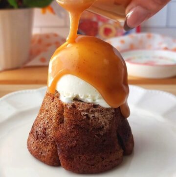 pouring caramel on top of Sticky Toffee Pudding